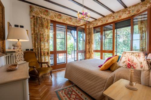 a bedroom with a bed and some windows at Villa Paradiso Apartment in Sirmione