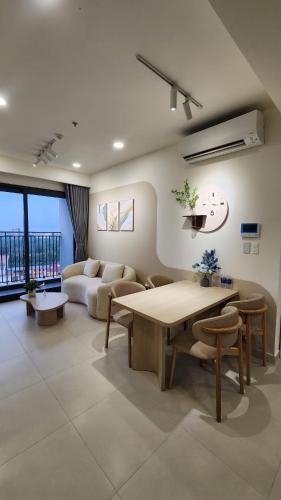 a living room with a couch and a table at Homie's The Glory Apartment in Thu Dau Mot