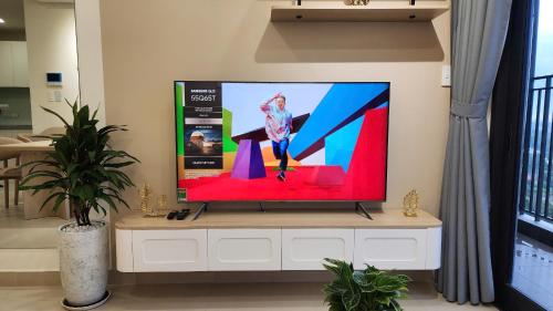 a flat screen tv sitting on top of a white cabinet at Homie's The Glory Apartment in Thu Dau Mot