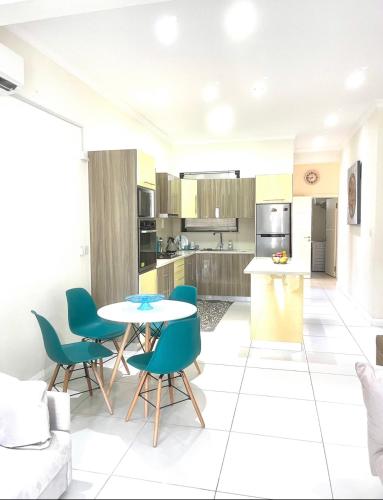 a kitchen and living room with a table and chairs at Blue Lagoon seafront apartment in Flic-en-Flac