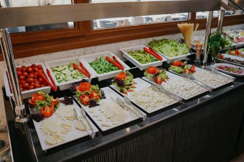 a buffet line with salads and vegetables in trays at Grand Karot Hotel in Yalova