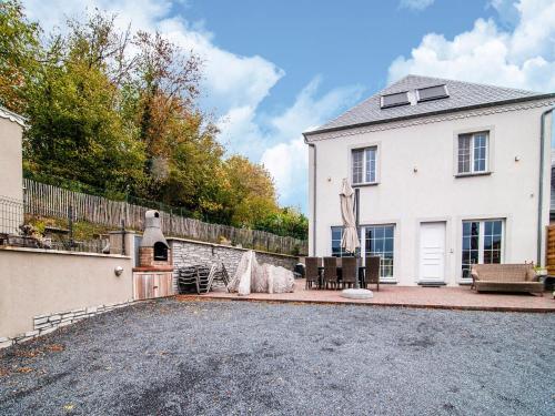 a white house with a fence and a driveway at Great holiday home in Bastogne with sauna in Le Parque
