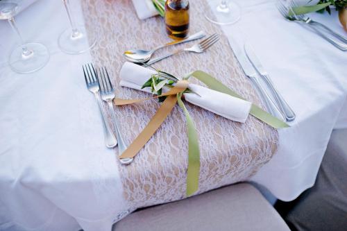 a table with a white table cloth with fork and knife at The Westin Resort, Costa Navarino in Romanós