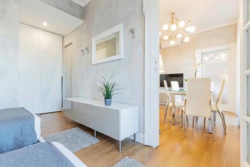 a bedroom with a white cabinet and a dining room at Milan Retreats in Milan