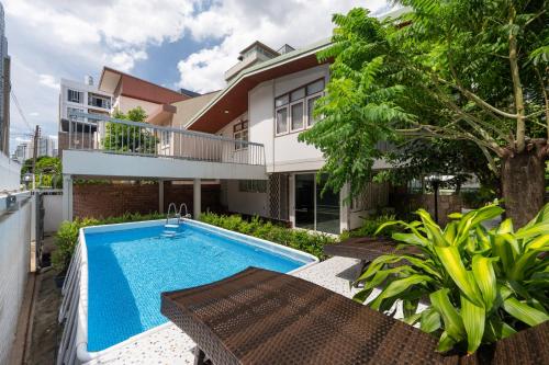 an image of a house with a swimming pool at MIQ S22 Pool Villa PhromPhong Emsphere 5BR in Bangkok