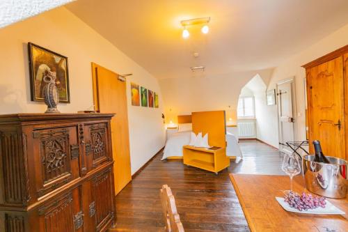 a living room with a large wooden cabinet and a table at Romantik Hotel Meisenheimer Hof in Meisenheim