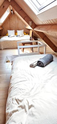 a bedroom with two beds in a attic at Bulbs & Beach in Noordwijk