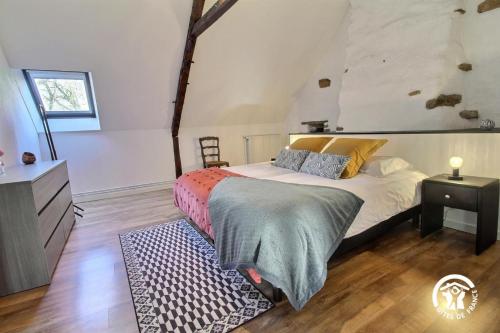 a bedroom with a bed and a dresser at Leontine in Saint-Hilaire