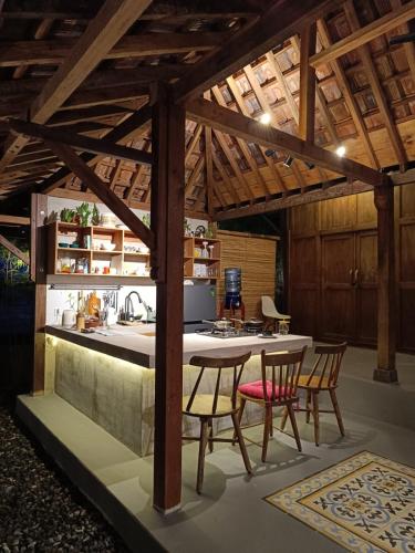 a kitchen with a table and chairs in a room at Yukke Tembi Homestay in Yogyakarta