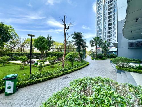 a walkway through a park with a tall building at Five Star Studio Apartment Near Marriott Hotel and Keangnam in Hanoi