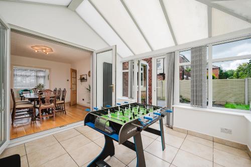 a living room with a foosball table in it at Heaton House - parkside charm and city comfort in Manchester