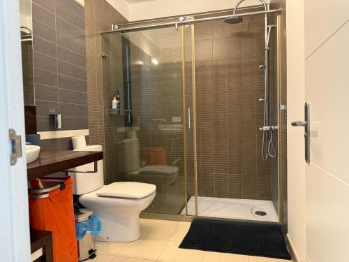 a bathroom with a toilet and a glass shower at Finca Seño Donato Lomo La Santa in Tinajo