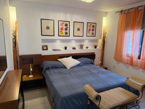 a bedroom with a blue bed and a chair at Finca Seño Donato Lomo La Santa in Tinajo
