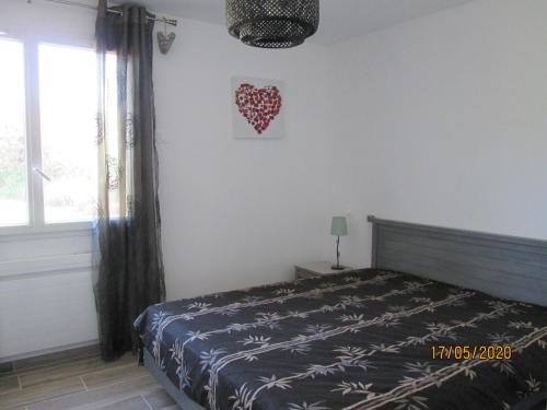 a bedroom with a bed and a heart on the wall at Modern holiday home in Crux-La-Ville with terrace in Crux-la-Ville
