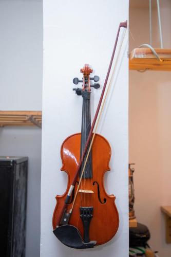 a violin hanging on a wall at Art Hotel Zanzibar in Jambiani