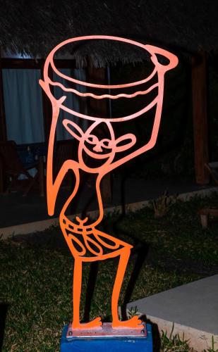 a neon sign of a person in a basket at Art Hotel Zanzibar in Jambiani
