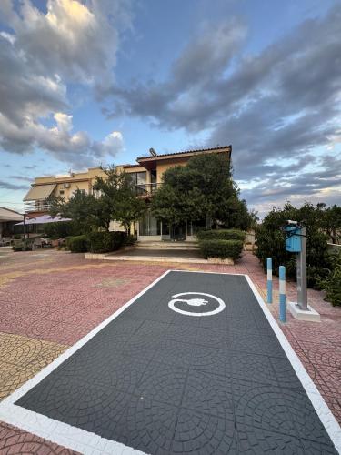 an empty parking lot with a no parking sign in front of a building at Vasilios Marinos Rooms in Korinthos