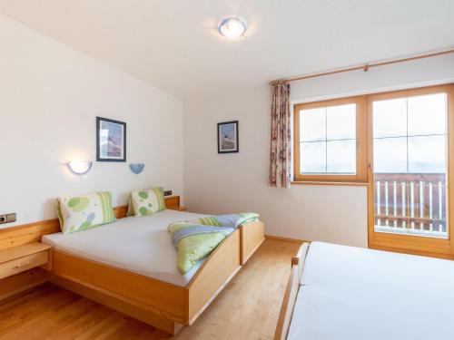 a bedroom with two beds and a window at Welcoming apartment in Stummerberg with terrace in Stummerberg
