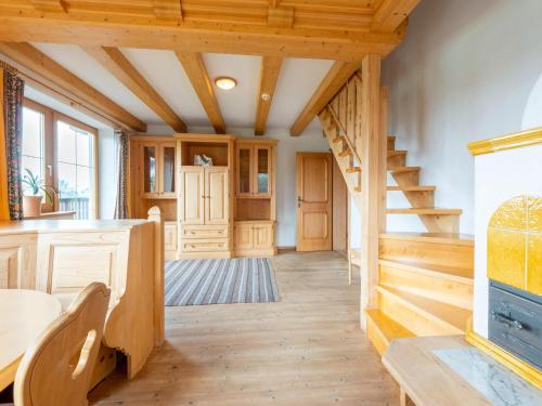 a large kitchen with wooden floors and wooden stairs at Welcoming apartment in Stummerberg with terrace in Stummerberg