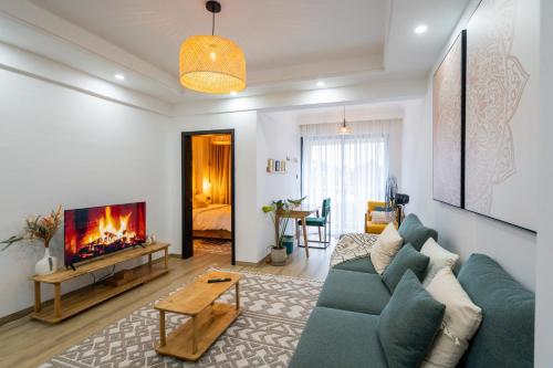 a living room with a blue couch and a fireplace at Marina Bay One Bedroom Apartment, Swimming pool, gym, workspace,JW Homes Westland Living in Nairobi