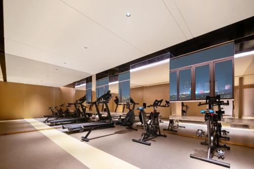 a gym with treadmills and elliptical machines at Platon International Apartment - Lunjiao Metro Station Store in Shunde