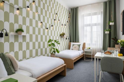 a therapy room with two beds and a table at Riverside Hotel by Goodnite cz in Brno