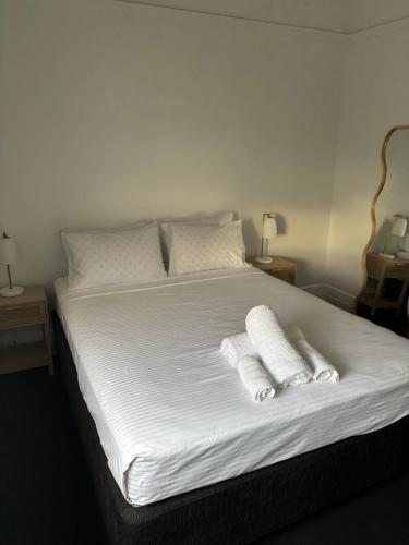 a bed with two white pillows on top of it at The Boatrowers Hotel in Stockton