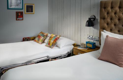 two beds sitting next to each other in a bedroom at Middletons in York