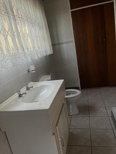 a bathroom with a sink and a toilet at Flora Gardens guest house in Vanderbijlpark
