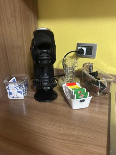 a black coffee maker sitting on a wooden table at Villa Penelope in Bollate