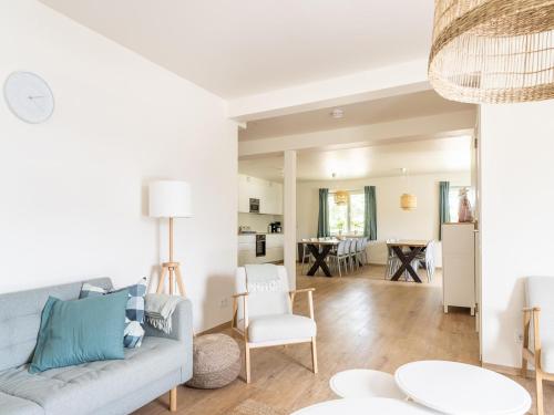 a living room with a couch and a table at Lovely apartment on Ameland near Nes in Nes