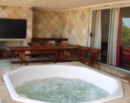 a bath tub filled with water in a living room at Shirleys Place in Brackenfell
