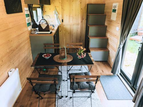 a dining table and chairs in a tiny house at Whispers of the Willow 2 by Tiny Away in Estramiac