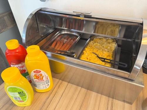 a counter with a tray of food and bottles of condiments at Hotel Pod Radnicí in Šumperk