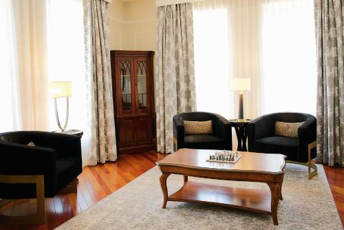 a living room with chairs and a coffee table at The Oxford Hotel in Denver