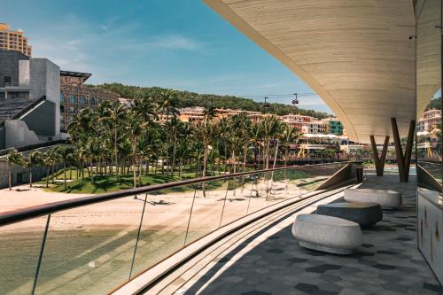 a view of a beach from a building with trees at The Hill Apartment - Phú Quốc - Firework & Ocean View in Phu Quoc