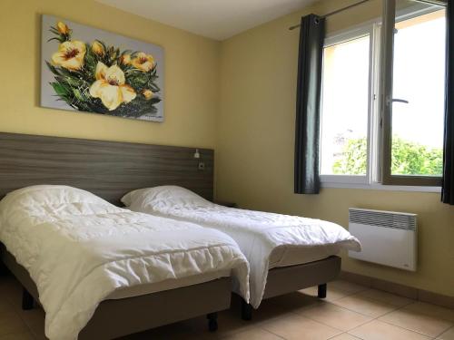 two beds in a bedroom with two windows at Spacious villa with garden and pool in Les Forges