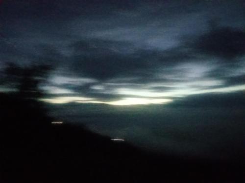 a view of a cloudy sky with the sun in the distance at Unique point home stay in Nagarkot