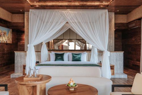 a bedroom with a bed with a canopy at Elevate Bali in Munduk
