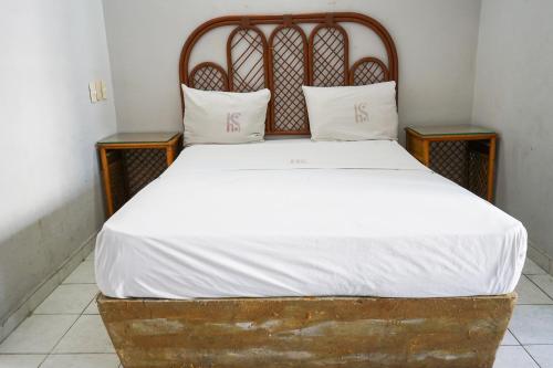a bed with white sheets and two pillows on it at OYO Hotel Santander Veracruz Centro Historico in Veracruz