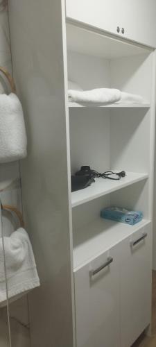 a white closet with white shelves and towels at CrystalLUS in Požega