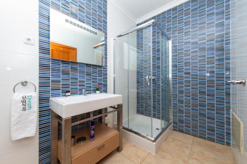 a bathroom with a sink and a shower at Lagos Central Wellness in Lagos