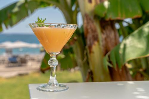 a drink in a glass sitting on a table at Rodos Palladium Leisure & Wellness in Faliraki