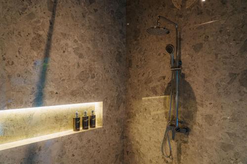 a shower stall in a bathroom with a shower head at Elevate Bali in Munduk