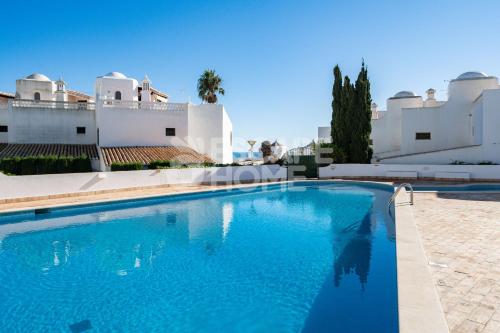 a swimming pool in front of a villa at Casa do Levante in Porches