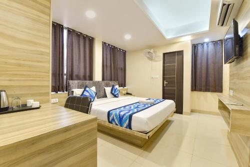 a hotel room with a bed and a desk at FabHotel Pink City - World Trade Park in Jaipur