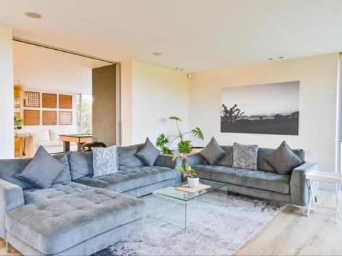 a living room with two couches and a table at GND Properties Luxury Apartment in Summerstrand