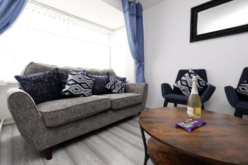 a living room with a couch and a table at Lovely 3-Bed in Scenic Aberdare! in Aberdare