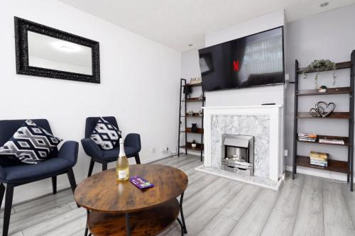 a living room with a fireplace and a tv at Lovely 3-Bed in Scenic Aberdare! in Aberdare