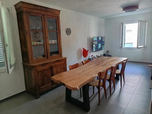 a dining room with a wooden table and chairs at Appartamento Giada in Casalgrande